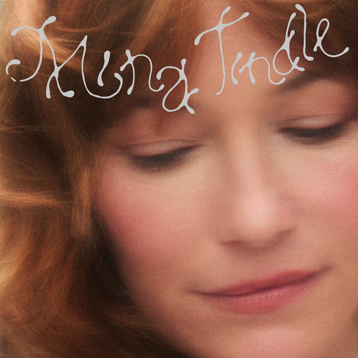 Compass Rosa album cover — close portrait with eyes lowered, red-brown hair, the name Mina Tindle in looping silver script